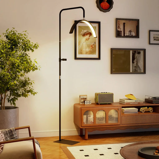 Modern living room with a floor lamp, wooden cabinet, and decorative items.