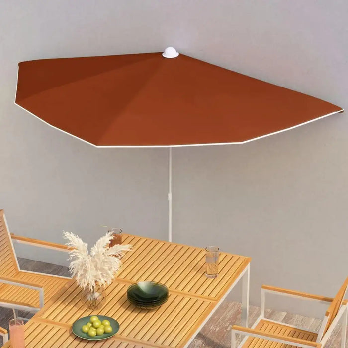 Half round terracotta garden parasol over wooden outdoor dining set on patio