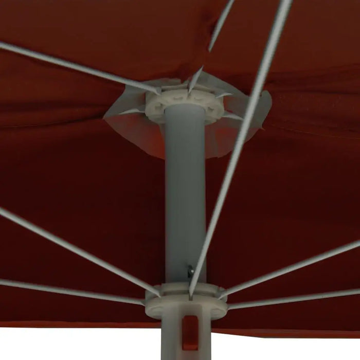 Half round garden parasol close-up with terracotta canopy and white metal frame