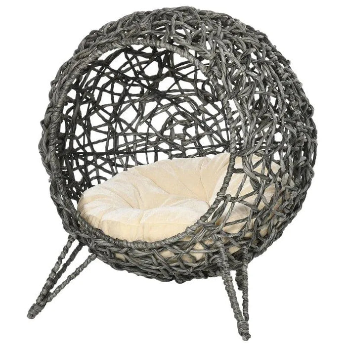 Hand-woven rattan cat house with cushion and tripod legs, elevated wicker cat basket