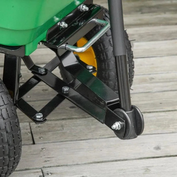 Close-up of heavy-duty garden dump cart wheels and metal frame on wooden deck