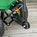 Close-up of heavy-duty garden dump cart wheels and metal frame on wooden deck