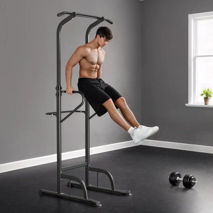 Man exercising on a pull-up bar in a home gym setting