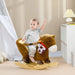 Toddler riding brown plush rocking horse with foot pedals in a nursery setting