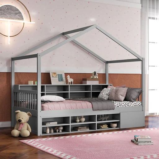 Children's room with a house-shaped bed, teddy bear, and books on a pink rug.