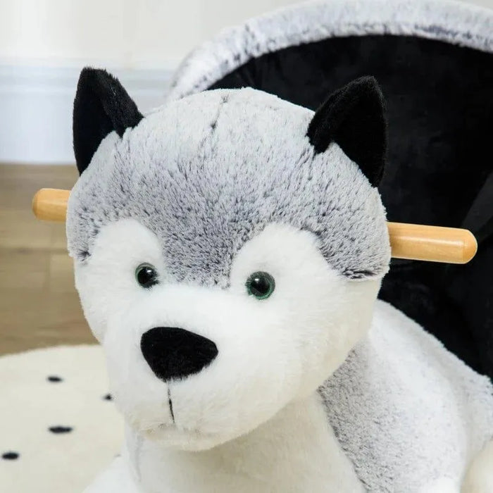 Grey and black plush husky rocking horse with wooden handles on a wooden floor