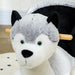 Grey and black plush husky rocking horse with wooden handles on a wooden floor