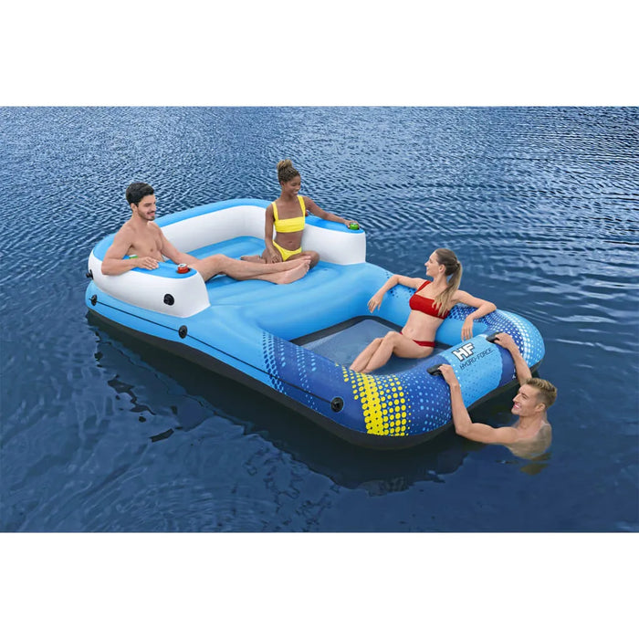 Four people relaxing on a Hydro-Force luxury inflatable floating lounger in blue water