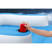 Hand placing red can in cup holder on blue and white inflatable luxury pool lounger
