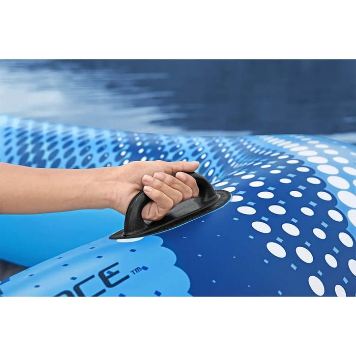 Hand holding handle on blue Hydro Force inflatable floating lounger on water