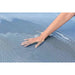 Hand touching blue mesh fabric on Hydro Force floating lounger surface