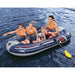 Three people in life jackets riding a Hydro-Force Treck X2 inflatable boat on water