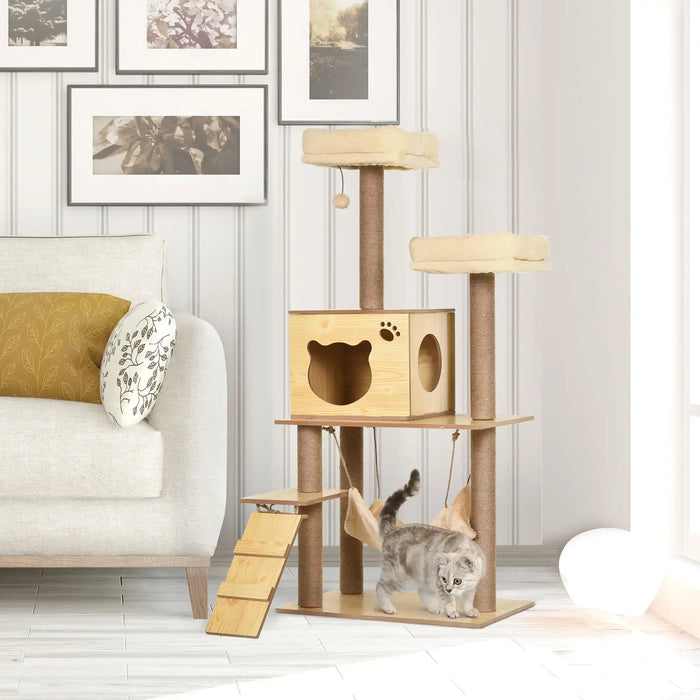 Gray cat walking near wooden multi-level beige cat tree with platforms and hammock in bright living room