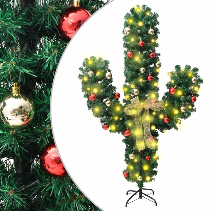 Artificial cactus Christmas tree decorated with red and gold baubles, yellow lights, and a golden bow