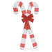 Christmas decoration of two large striped candy canes crossed with a glittery red bow