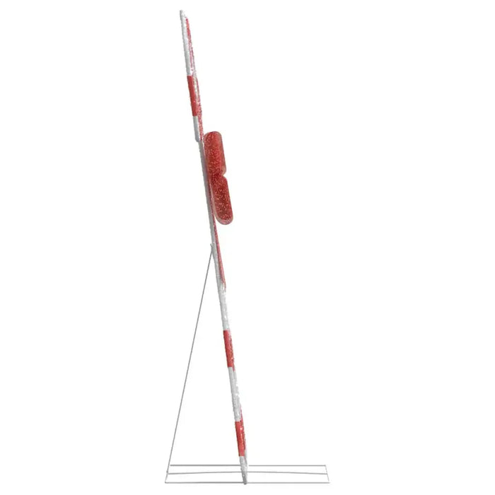 Side view of red and white striped barrier gate arm with reflective elements on a metal stand