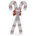 Large wireframe Christmas decoration of two crossed red and white candy canes with a red bow