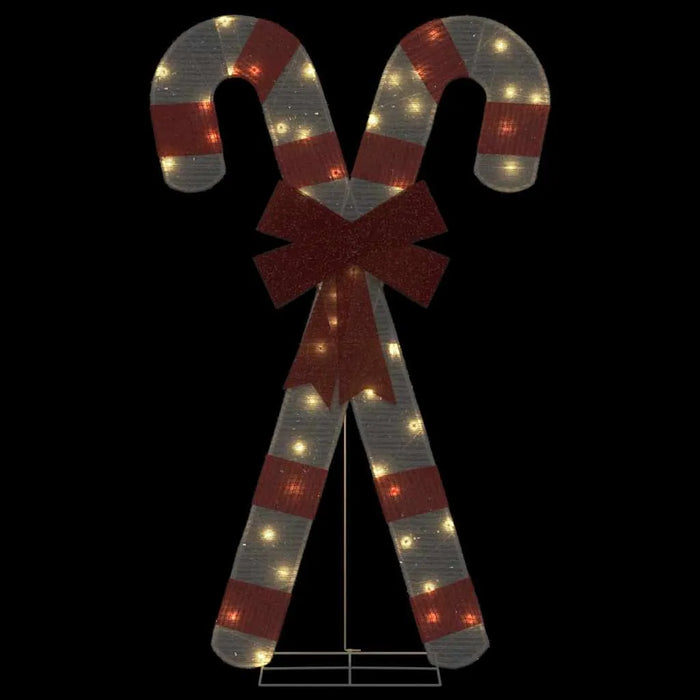 Decorative lighted holiday candy canes with red stripes and a large red bow
