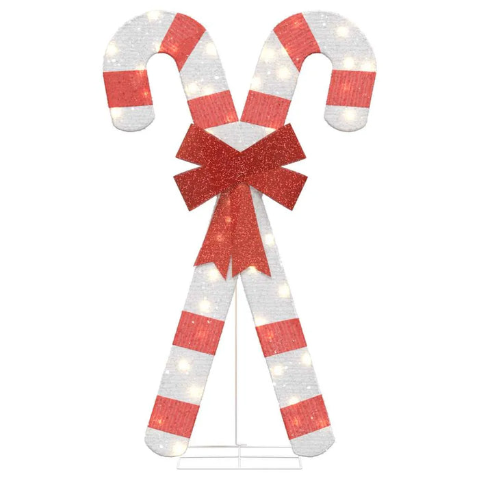 LED lit Christmas candy cane decoration with red stripes and glittery red bow on white background