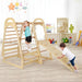 Children playing on a wooden climbing frame with slide in a room.