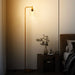 Floor lamp in a bedroom setting with a warm glow