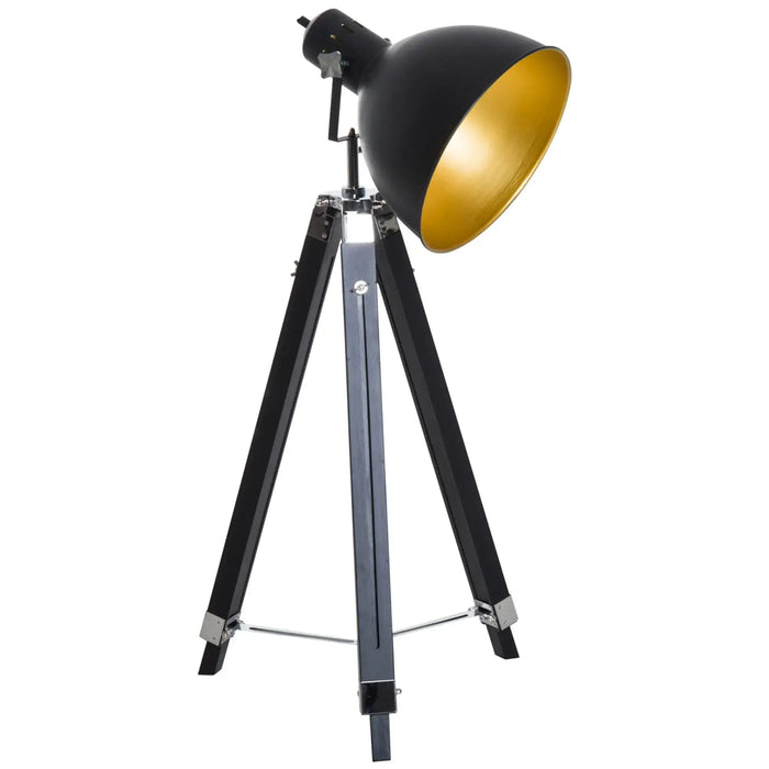 Black and gold tripod lamp on a white background