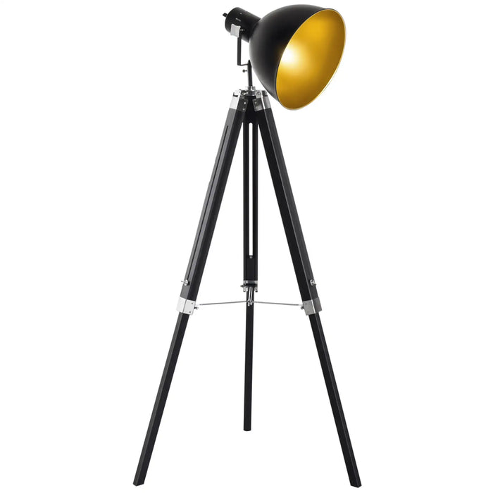 Black tripod floor lamp with a gold lampshade on a white background