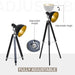 Adjustable tripod floor lamp with black and gold design on a white background
