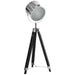Floor lamp with a silver circular shade and black tripod base on a white background