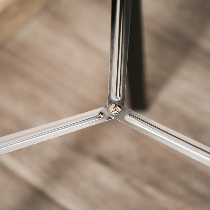 Close-up of a metallic tripod leg with a blurred background