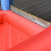 Close-up of inflatable bouncy house with red floor and mesh safety netting