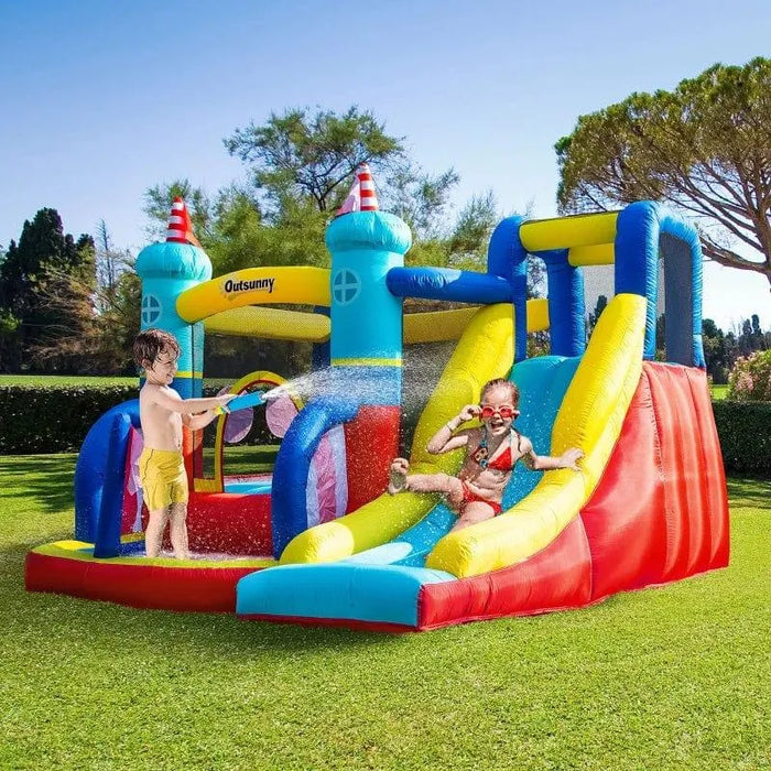Kids playing on colorful inflatable castle with slide, pool, and climbing wall outdoors