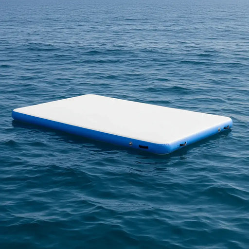 Inflatable floating water deck platform with blue edges on calm ocean water.
