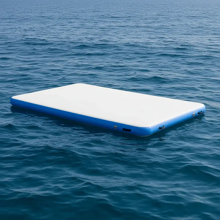 Inflatable floating water deck platform with blue edges on calm ocean water.