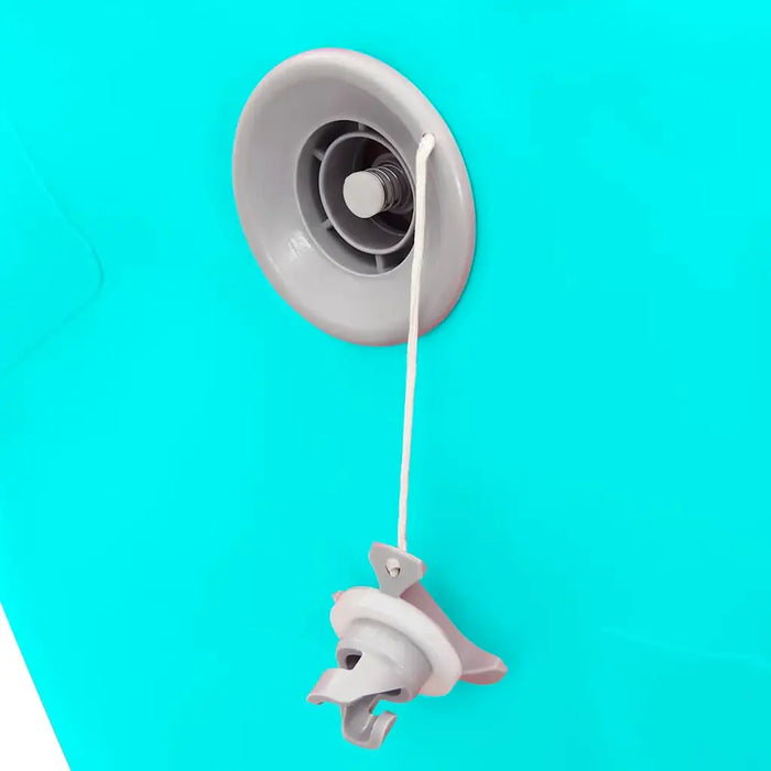 Close-up of gray inflatable valve with attached cap on bright turquoise surface