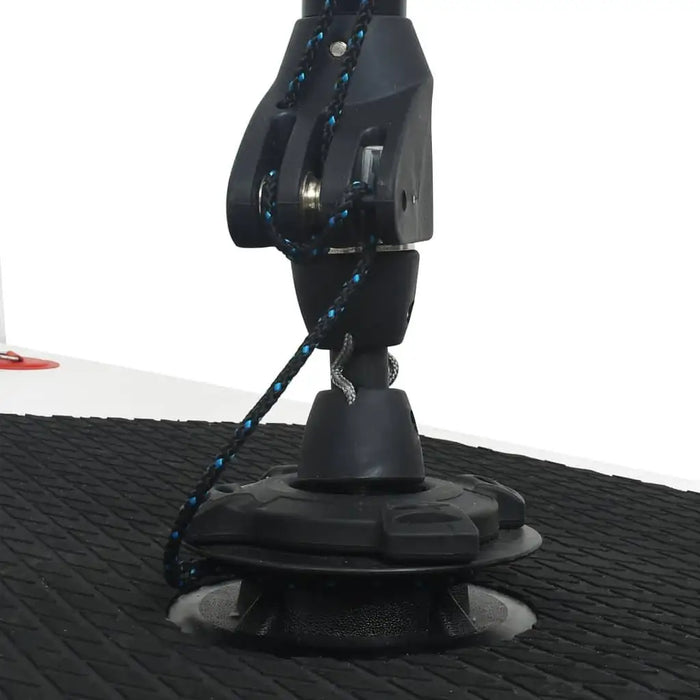 Close-up of SUP board sail mount with black textured EVA deck and sail attachment hardware.