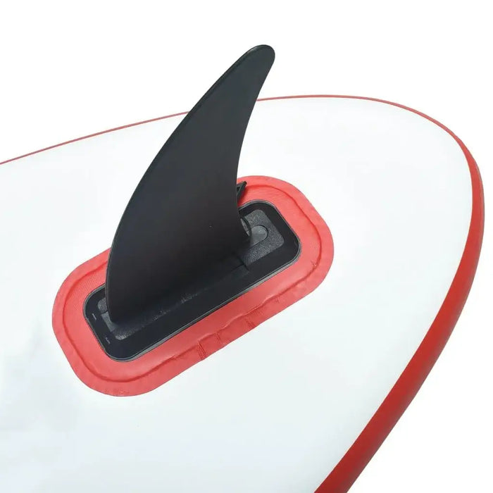 Close-up of inflatable red SUP board with black fin, white PVC and EVA construction