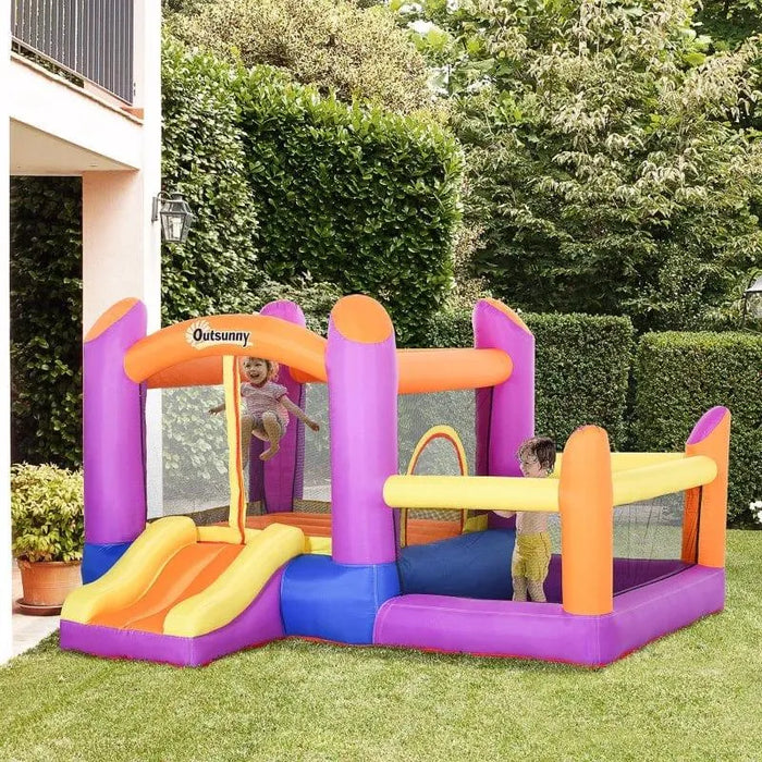 Kids playing on colorful inflatable water park castle with slide and pool in backyard
