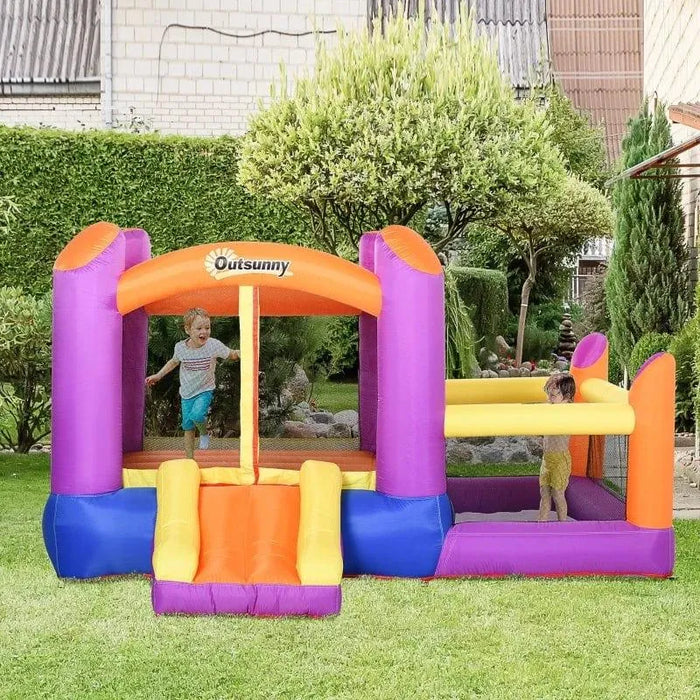 Kids playing on inflatable Outsunny water park castle with trampoline, slide, and pool in garden