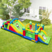 Colorful inflatable obstacle course with children sliding and bouncing on green lawn in backyard