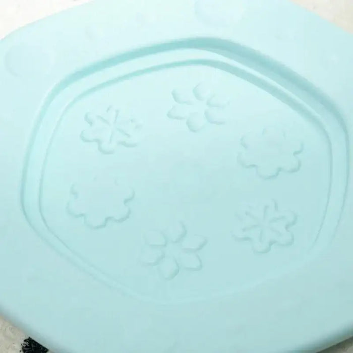 Close-up of light blue kids balance board with embossed flower-shaped patterns.