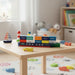 Wooden toy container ship with colorful magnetic containers on a child’s table in a bright playroom