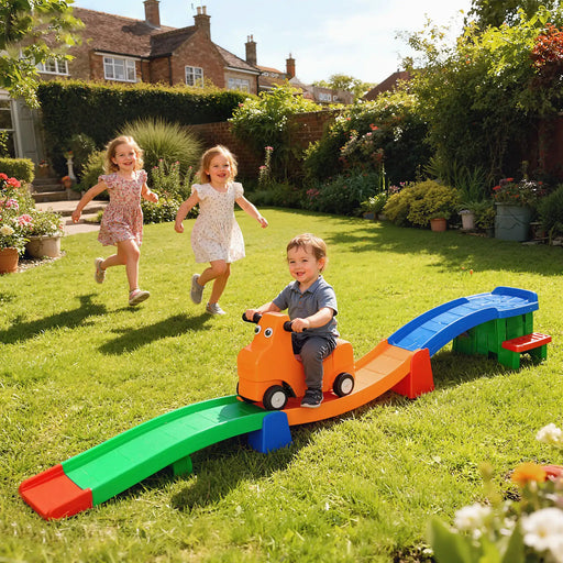 Children playing with a colorful toy track set in a garden.