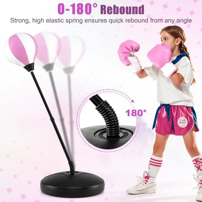 Child in pink boxing gloves punching pink and white rebound punching bag with flexible spring stand