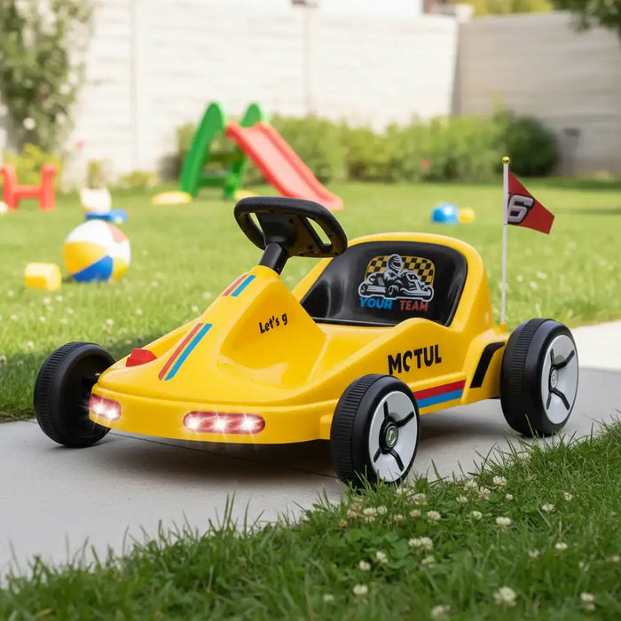 Yellow toy car with racing decals on a grassy area