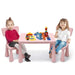 Two kids sitting at a pink activity table with chairs, playing with colorful building blocks.