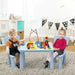 Kids activity table and two chairs set in blue with children playing in a nursery room