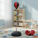 Children's room with red and black punching bag, red boxing gloves, bookshelf and table with wooden blocks