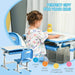 Child using blue height adjustable kids desk and chair set with storage and organizer, Homcom