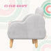 Grey cloud-shaped kids armchair with wooden legs on pastel abstract background